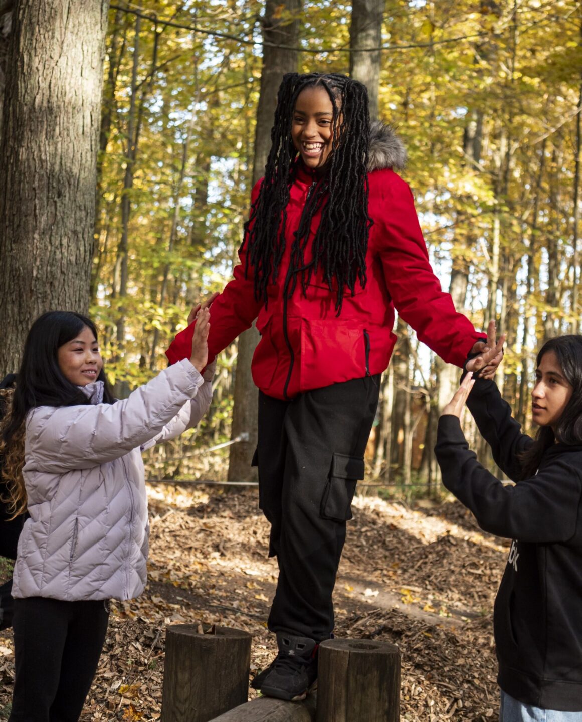 Youths at Trails working helping a girl outside